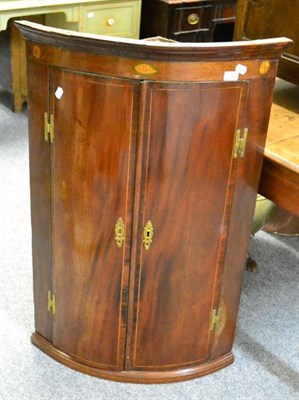 Lot 1469 - A George III mahogany wall mounted corner cupboard