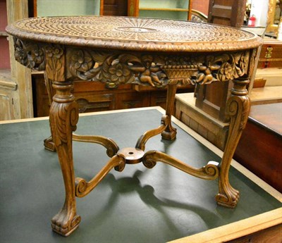 Lot 1477 - A early 20th century carved walnut circular centre table with circular cane top