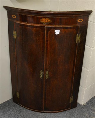 Lot 1487 - A George III oak and mahogany crossbanded hanging corner cupboard and a trestle dressing table...