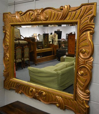 Lot 1495 - A gilt framed bevel glass mirror, 160cm wide