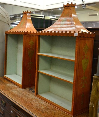 Lot 1500 - A pair of satinwood and green painted pagoda top cabinets, painted with ribbon tied motifs,...