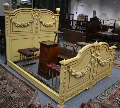 Lot 1526 - An impressive gilt and yellow painted bedstead with fruit and leaf swags, takes 6' mattress