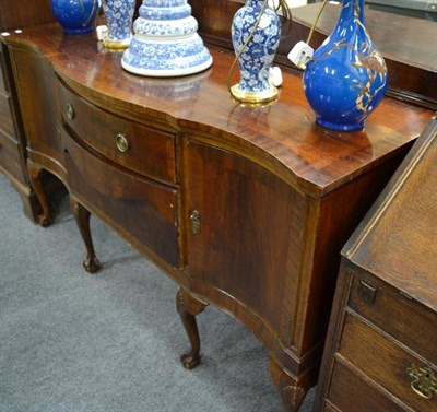 Lot 1546 - A mahogany serpentine shaped sideboard, labelled H Binns & Co, Newcastle-Upon-Tyne