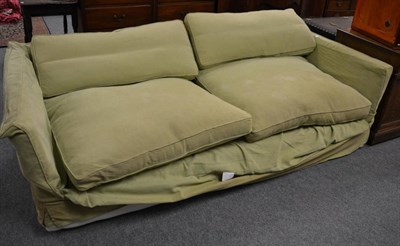 Lot 1548 - A large modern settee with green loose covers, 230cm wide; together with a 6' headboard