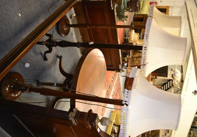 Lot 1559 - ^Three mahogany standard lamps with shades