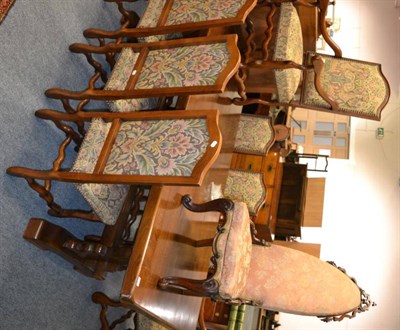 Lot 1569 - #A substantial oak dining table, together with eight dining chairs upholstered in close nailed...