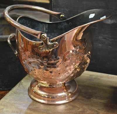 Lot 1642 - A copper embossed scuttle