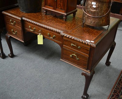 Lot 1643 - ^A reproduction mahogany inverted breakfront desk on claw and ball feet