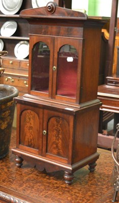 Lot 1645 - A Victorian mahogany miniature bookcase or table cabinet, circa 1860, the upper section with a...