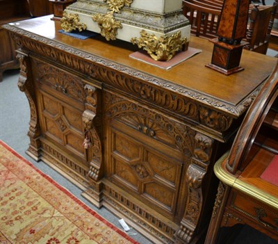 Lot 1659 - A 19th century Renaissance revival oak side cabinet with two frieze drawers above twin cupboard...