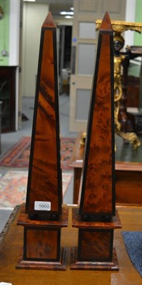 Lot 1660 - A pair of birdseye maple and ebony wooden obelisks on balled pedestals