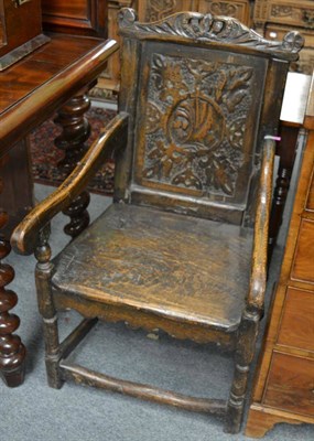 Lot 1672 - An early 18th century joined oak Wainscott armchair, with carved top rail and panel back