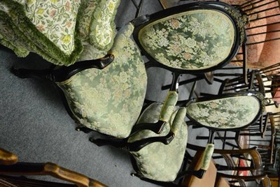 Lot 1700 - A pair of Victorian ebonised framed armchairs with gilt metal decoration, upholstered arms,...