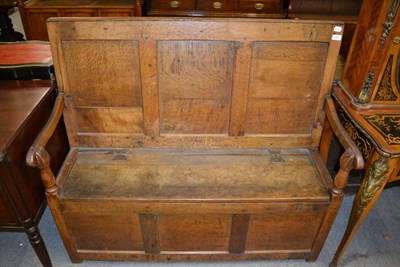 Lot 1710 - An oak three panelled box settle