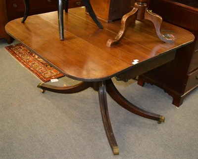 Lot 1720 - A George III mahogany drop leaf sofa table, raised on turned support and four reeded legs,...