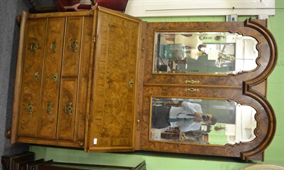 Lot 1758 - A walnut bureau bookcase, in three sections, the swan neck pediment above two cupboard doors...