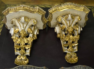 Lot 1768 - A pair of painted and gilt scrolling wall sconces with gilt metal to gallery, 29cm high