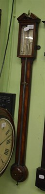 Lot 1782 - A mahogany stick barometer, circa 1820, broken arched pediment, exposed mercury tube with a...