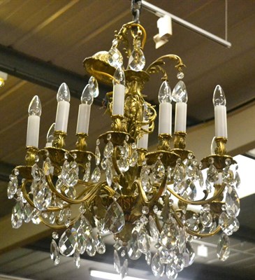 Lot 1785 - A modern brass effect chandelier with cut glass drops