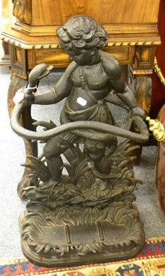 Lot 1793 - A cast iron stick/umbrella stand in the form of a boy holding a snake