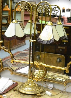 Lot 1794 - A brass twin branch table lamp in the Tiffany style