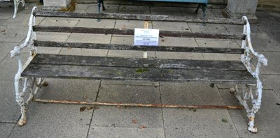 Lot 1803 - A Victorian cast iron garden seat with wooden slats and dog`s head terminals, 193cm wide