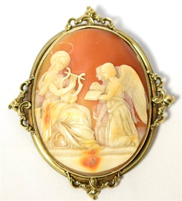 Lot 8 - A cameo brooch, the oval carved shell cameo depicting a religious scene within a scroll frame,...