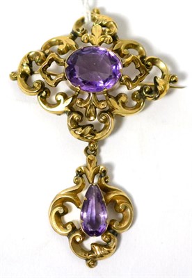 Lot 9 - A Victorian amethyst brooch, an oval cut amethyst in a yellow claw setting within a scrolling...
