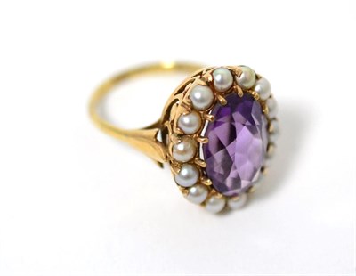 Lot 15 - An amethyst and split seed pearl cluster ring, an oval cut amethyst within a border of seed...