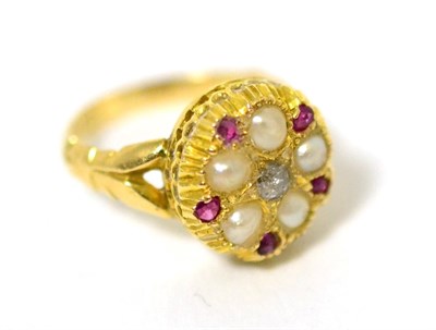 Lot 18 - A diamond, ruby and split seed pearl ring, star set with an old cut diamond within a border of...