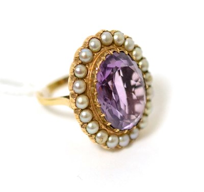Lot 20 - An amethyst and split seed pearl cluster ring, an oval cut amethyst within a border of seed...