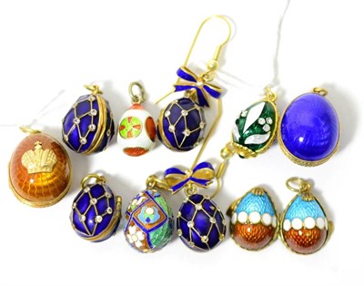 Lot 29 - Eight egg charms, enamelled in assorted colours, some set with white paste stones and some...