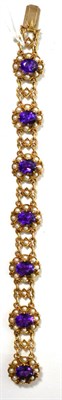 Lot 45 - A 9ct gold amethyst and split seed pearl bracelet, formed of seven cluster links each with a...