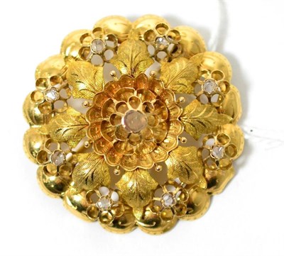 Lot 50 - A diamond set brooch, a cut diamond in a yellow rubbed over setting within a flower and leaf...