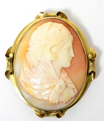 Lot 52 - A cameo brooch, the oval carved shell cameo depicting a portrait of young Hercules in a lion...