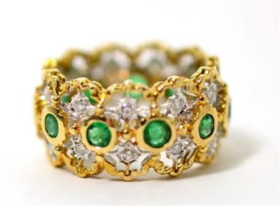 Lot 61 - An emerald and diamond hoop ring, round cut emeralds in yellow rubbed over settings, spaced by...