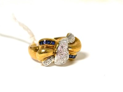 Lot 68 - A sapphire and diamond bow ring, pavé set with round brilliant cut diamonds and channel set...