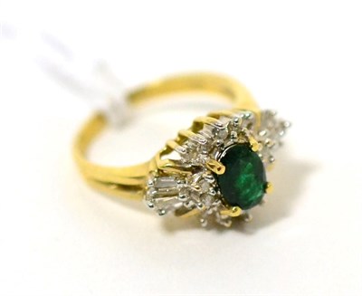 Lot 72 - An emerald and diamond cluster ring, an oval cut emerald in yellow claw setting within a border...