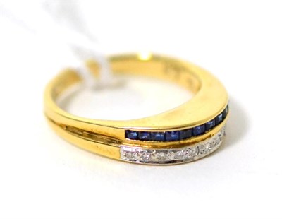Lot 73 - A sapphire and diamond ring, a band of channel set step cut sapphires and a band of pavé set round