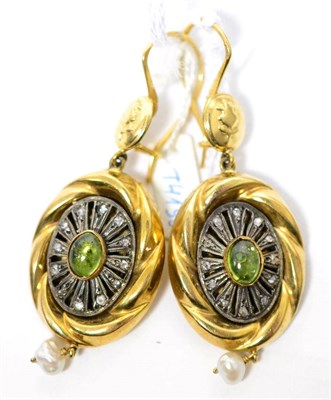 Lot 84 - A pair of peridot and cultured pearl drop earrings, a floral motif stud suspends an oval...