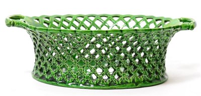 Lot 109 - A green glazed oval basket, circa 1770, with twin scroll handles, 22cm wide
