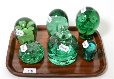 Lot 115 - Four Victorian green glass dumps enclosing vases of flowers, the largest 12cm; a similar dump...