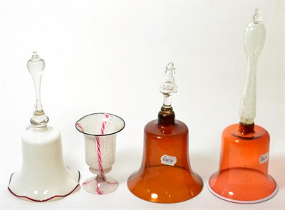 Lot 116 - Two ruby glass table bells, tallest 37cm high; a white glass table bell; and a latticino glass...