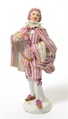 Lot 130 - A Meissen porcelain figure of an 18th century gentleman in a striped hat, cloak, jacket and...