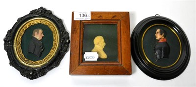 Lot 136 - A wax silhouette portrait of an officer, 9cm, in an ebonised frame; and two further wax...