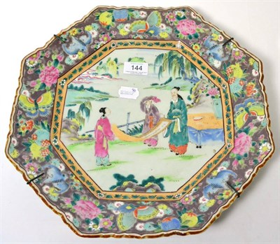 Lot 144 - A Chinese porcelain octagonal dish, painted with figures in landscape within a foliate border, 36cm