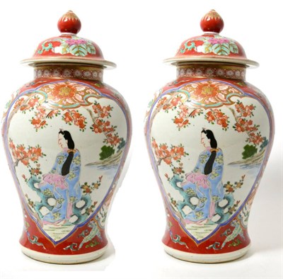 Lot 151 - A pair of Japanese porcelain baluster vases and covers, Meiji, painted with maidens in panels...
