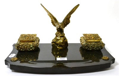 Lot 160 - A brass and slate inkstand, with central eagle flanked by two ink pots, 42cm wide