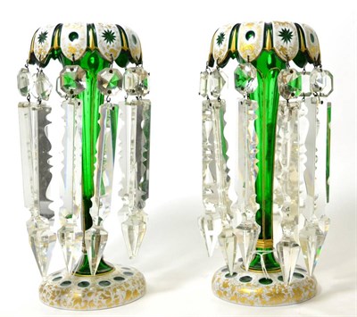 Lot 165 - A pair of 19th century Bohemian white overlay green glass table lustres, hung with prismatic drops
