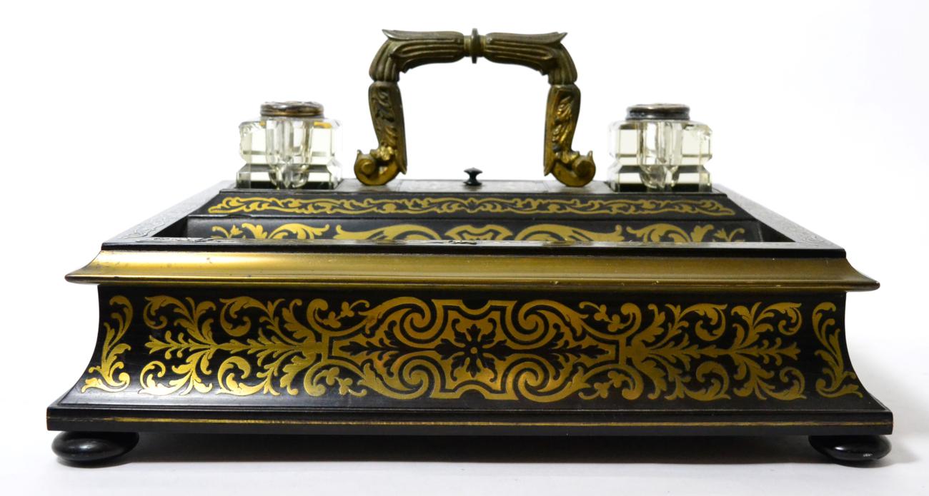 Lot 167 - A mid 19th century brass mounted and inlaid ebonised wood inkstand, with central handle flanked...